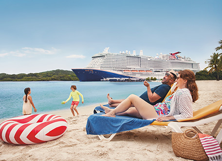 Family relaxing on a tropical beach with a cruise ship anchored offshore
