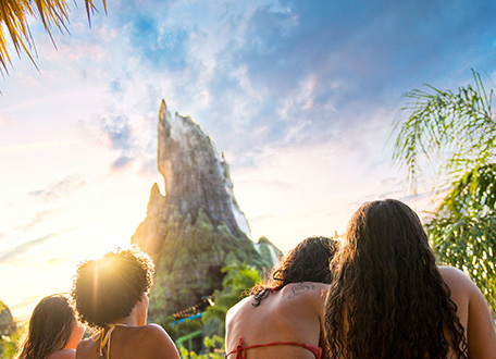 Guests looking toward the Krakatau volcano at Universal Volcano Bay at sunset